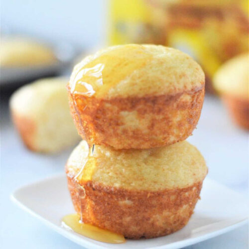 A stack of two yogurt muffins made from pancake mixture with a drizzle of honey on top