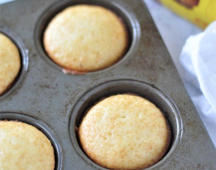 Golden muffins baked in a grey muffin tin