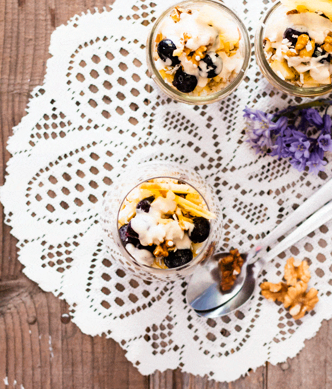 Overnight oats made with leftover quinoa served in glasses and topped with fresh fruit