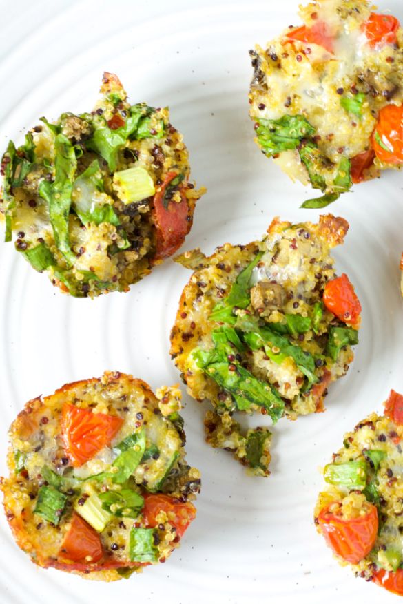 Overhead shot of baked quinoa pizza breakfast bites on a white plate