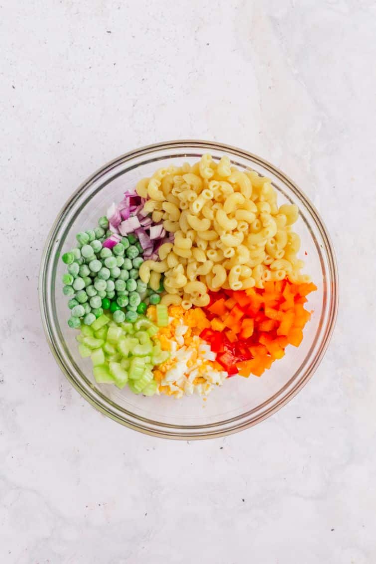 A rainbow of salad ingredients in a large glass bowl