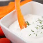easy homemade ranch dip served in a small white bowl surrounded by raw veggies