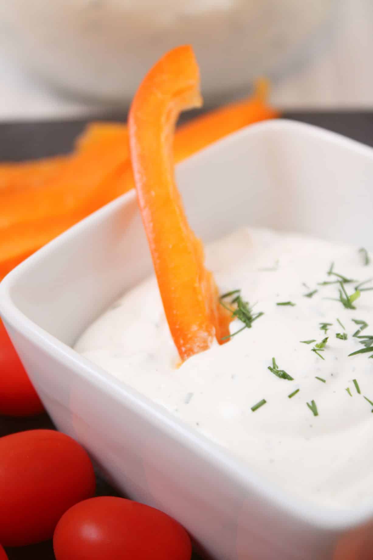 easy homemade ranch dip served in a small white bowl surrounded by raw veggies
