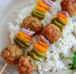 Sweet and sour chicken and meatballs on skewers