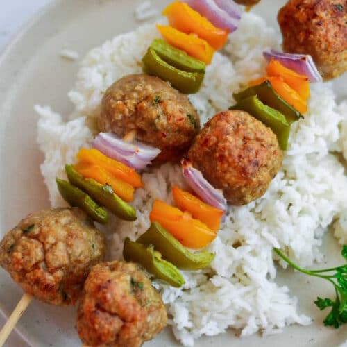 Sweet and sour chicken and meatballs on skewers