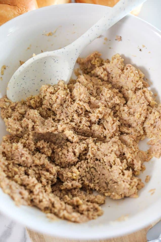 Canned tuna mixed with eggs, panko breadcrumbs and seasoning in a large white bowl